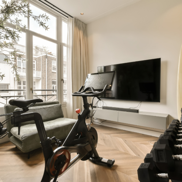 Home gym with hardwood flooring