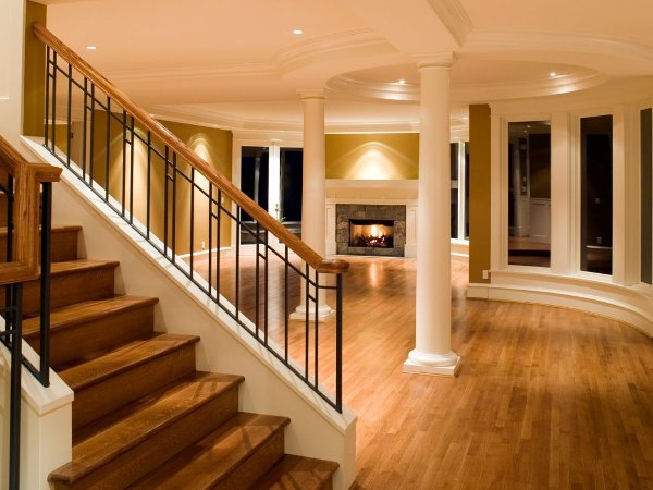 Hardwood flooring on a staircase in an empty open living room