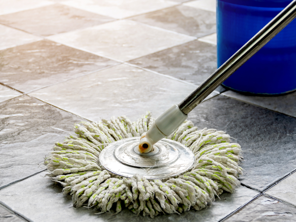 Mop cleaning a tile floor