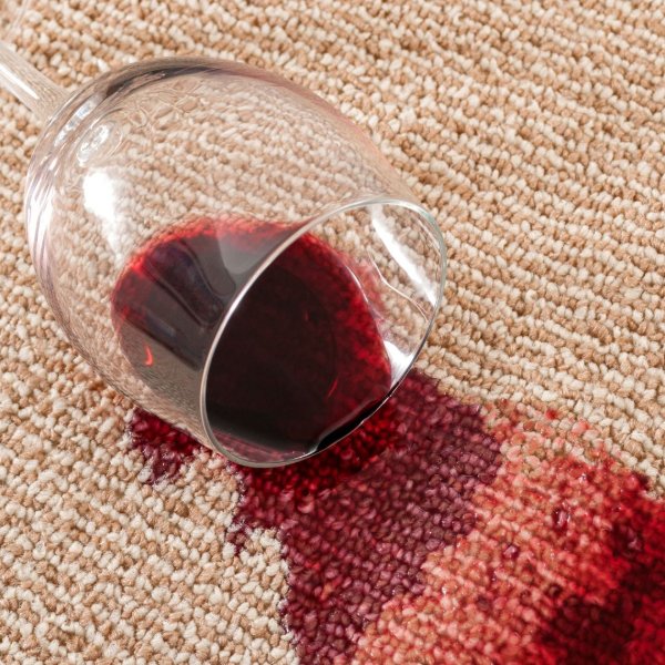 Red wine stain on a beige carpet floor