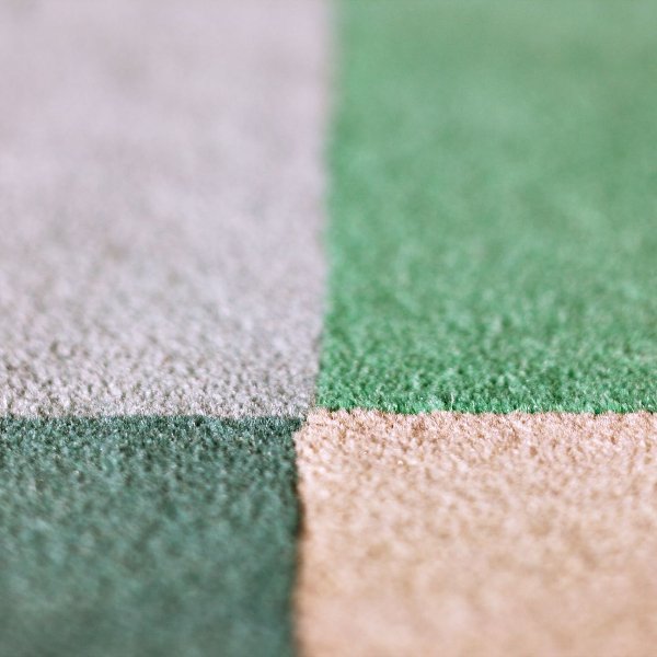 Green and beige checkered carpet tiles