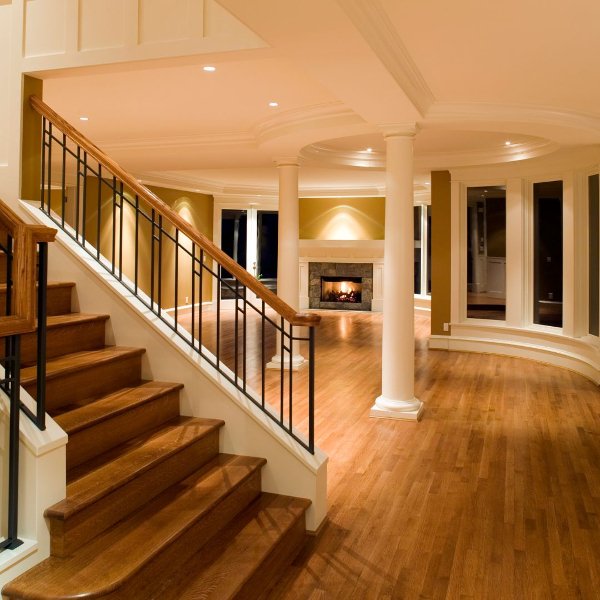 Staircase with hardwood flooring in an open traditional style home